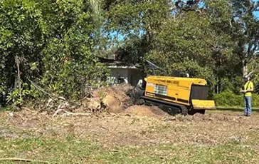 Deep stump grinding in Northeast Florida to stop regrowth and clear roots for underground utility safety.
